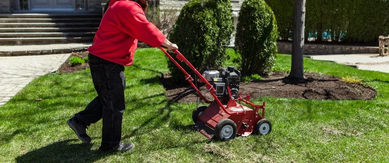 person pushing aerator machine