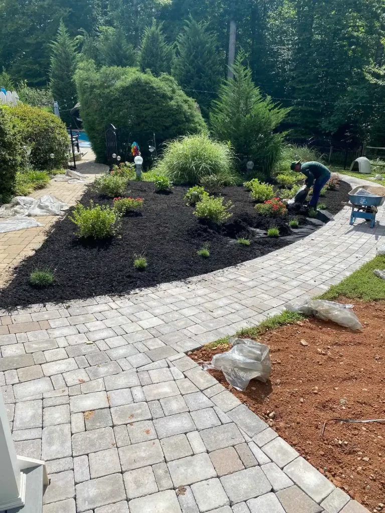 man putting black mulch