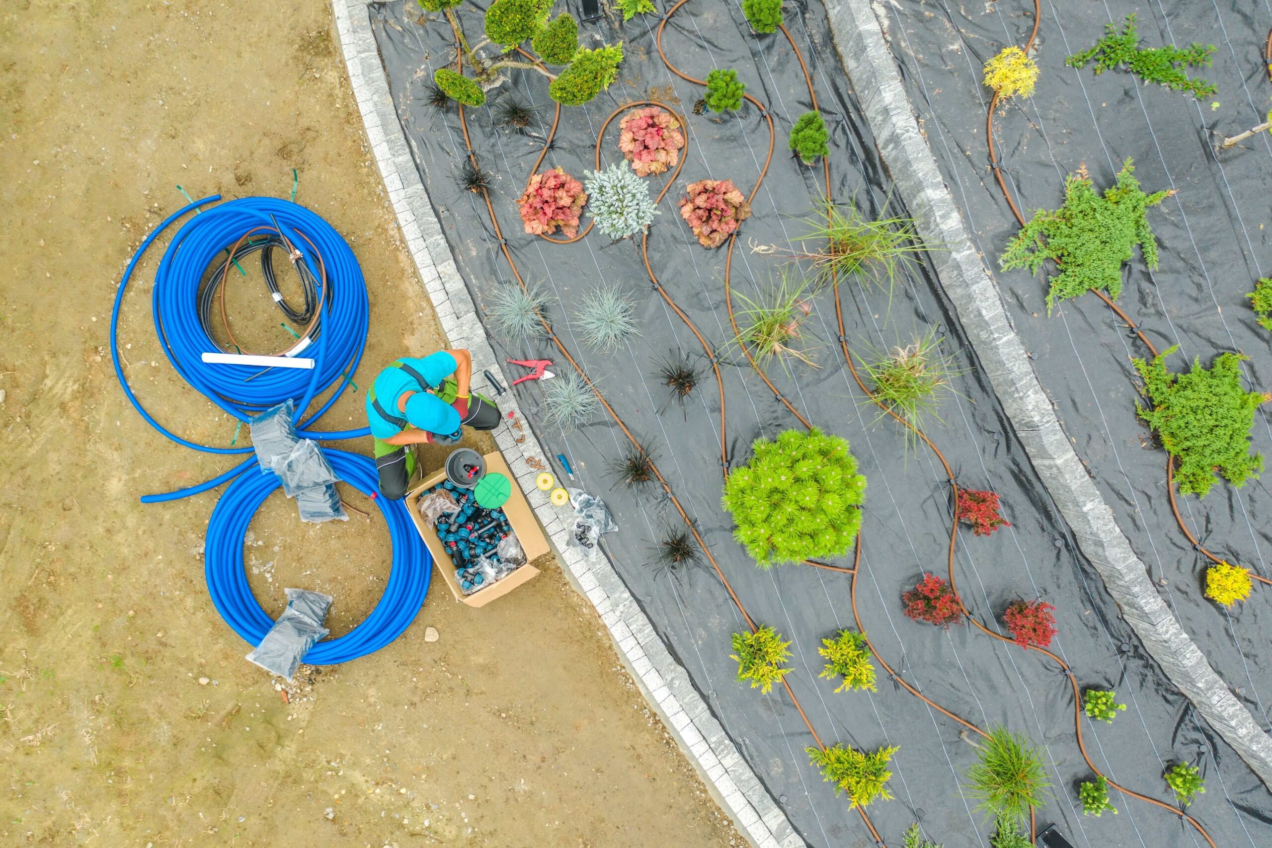 Aerial view of a landscaper performing an irrigation system installation service